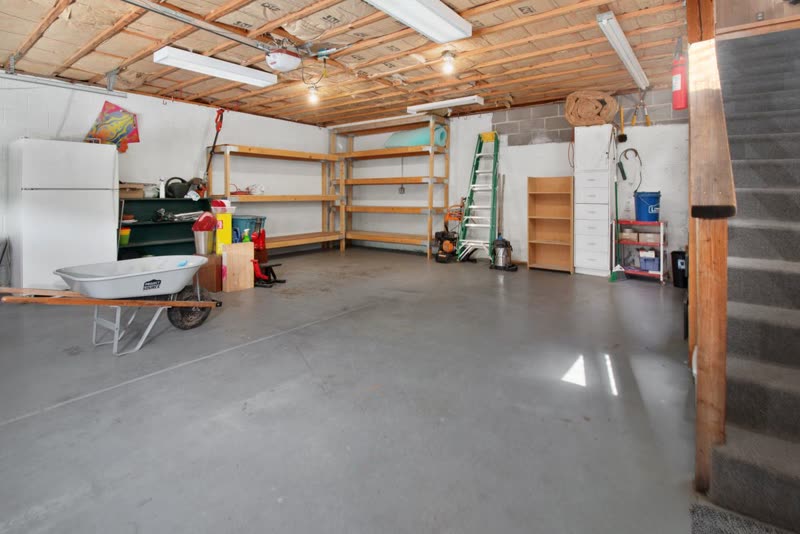 Concrete floor inside a residential garage with shelving
